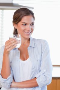 Portrait of a woman holding a glass of water
